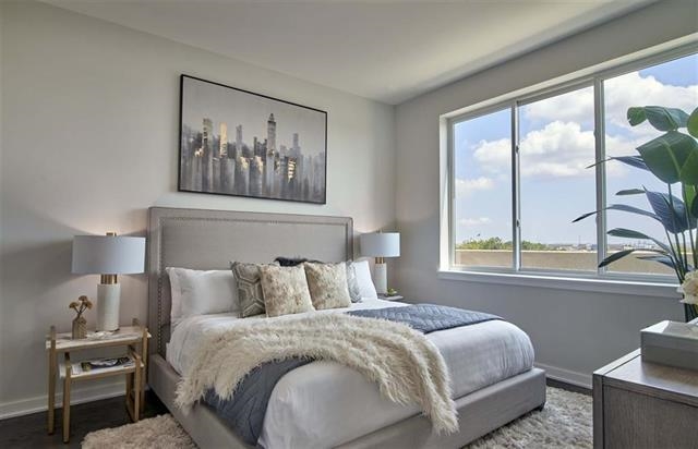 250 Ave East, Unit 611 Bayonne, NJ 07002 - Photo 5 of 17 a bedroom with a large bed and a window