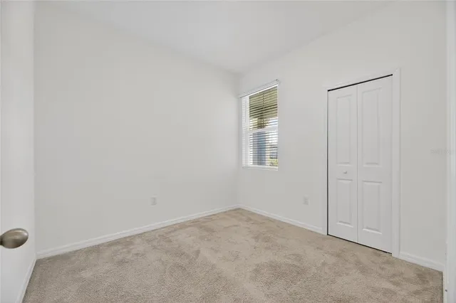 a view of a storage & utility room with refrigerator and natural light