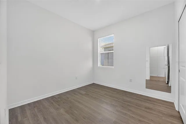 wooden floor in an empty room with a window