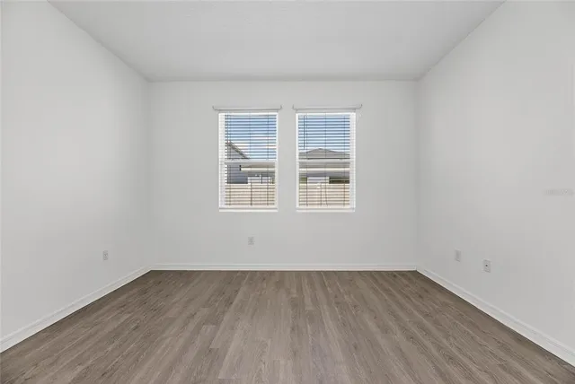 a view of a backyard with plants and a barn