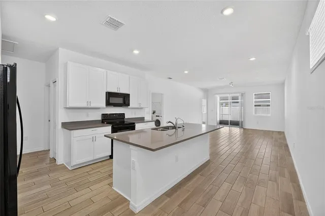 a kitchen with stainless steel appliances granite countertop a stove and a sink