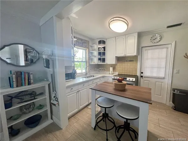 a kitchen with stainless steel appliances a sink and cabinets