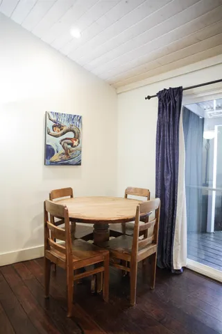 a view of a workspace with furniture and wooden floor