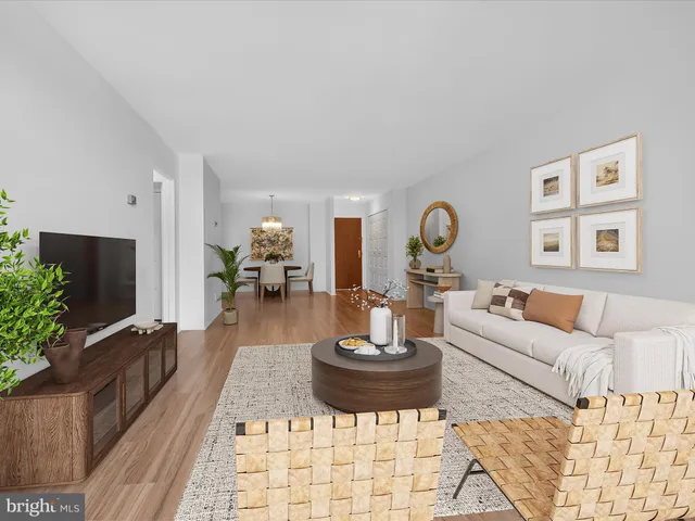 a living room with furniture a rug and a flat screen tv