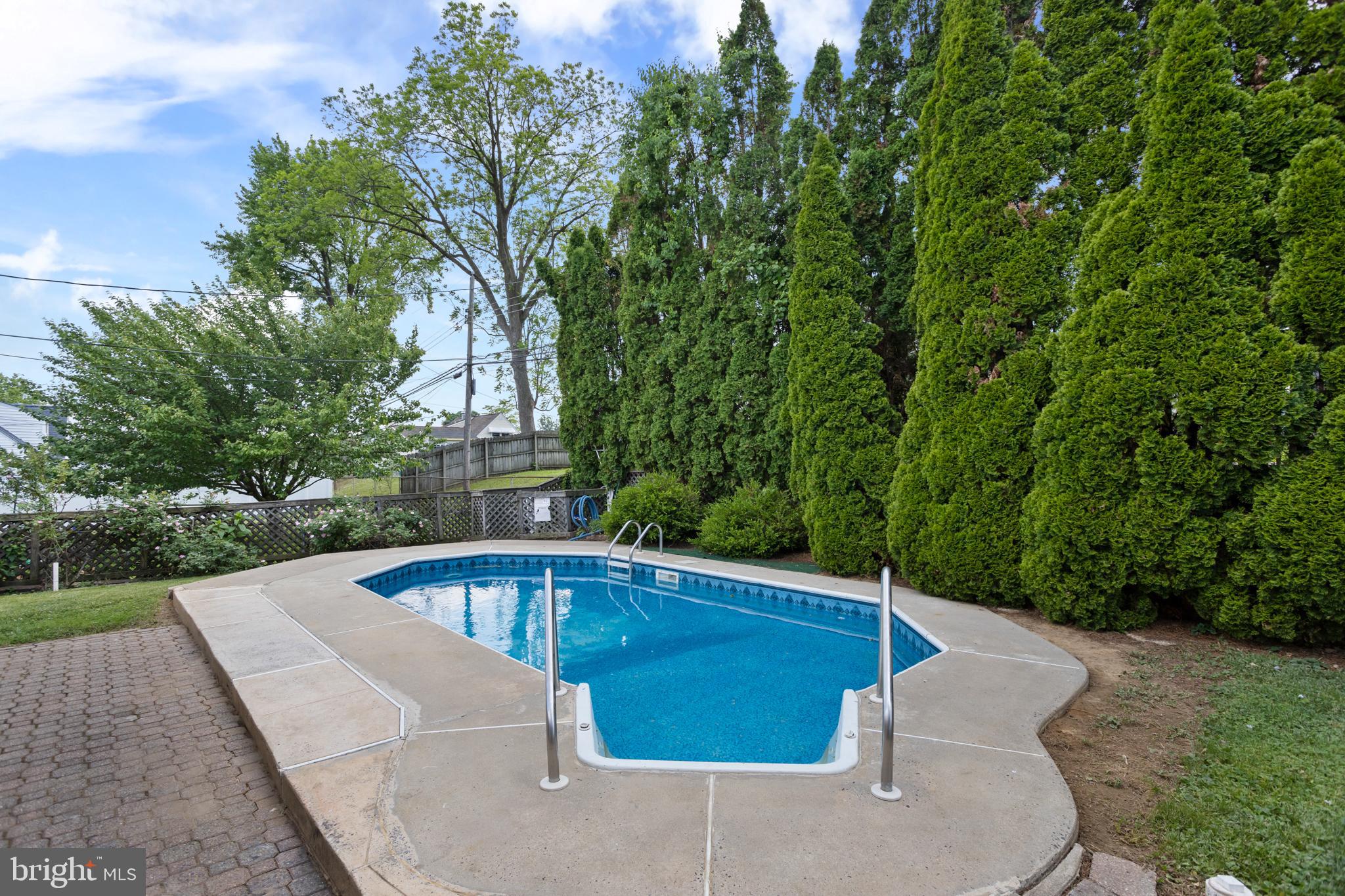 23 Cotton Road Levittown, PA 19057 - Photo 29 of 36 a view of backyard with swimming pool and outdoor seating
