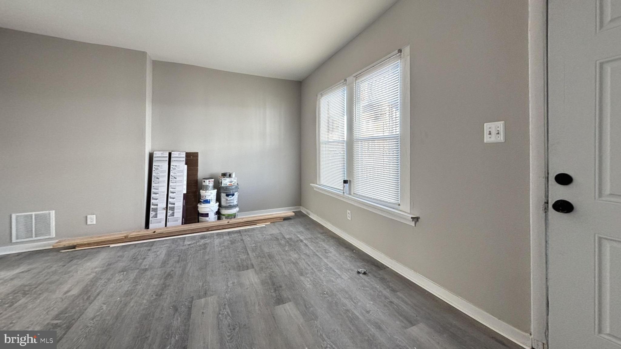 wooden floor in an empty room with a window