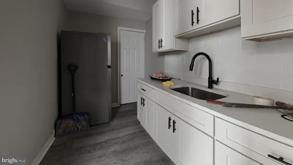 a kitchen with a sink and cabinets