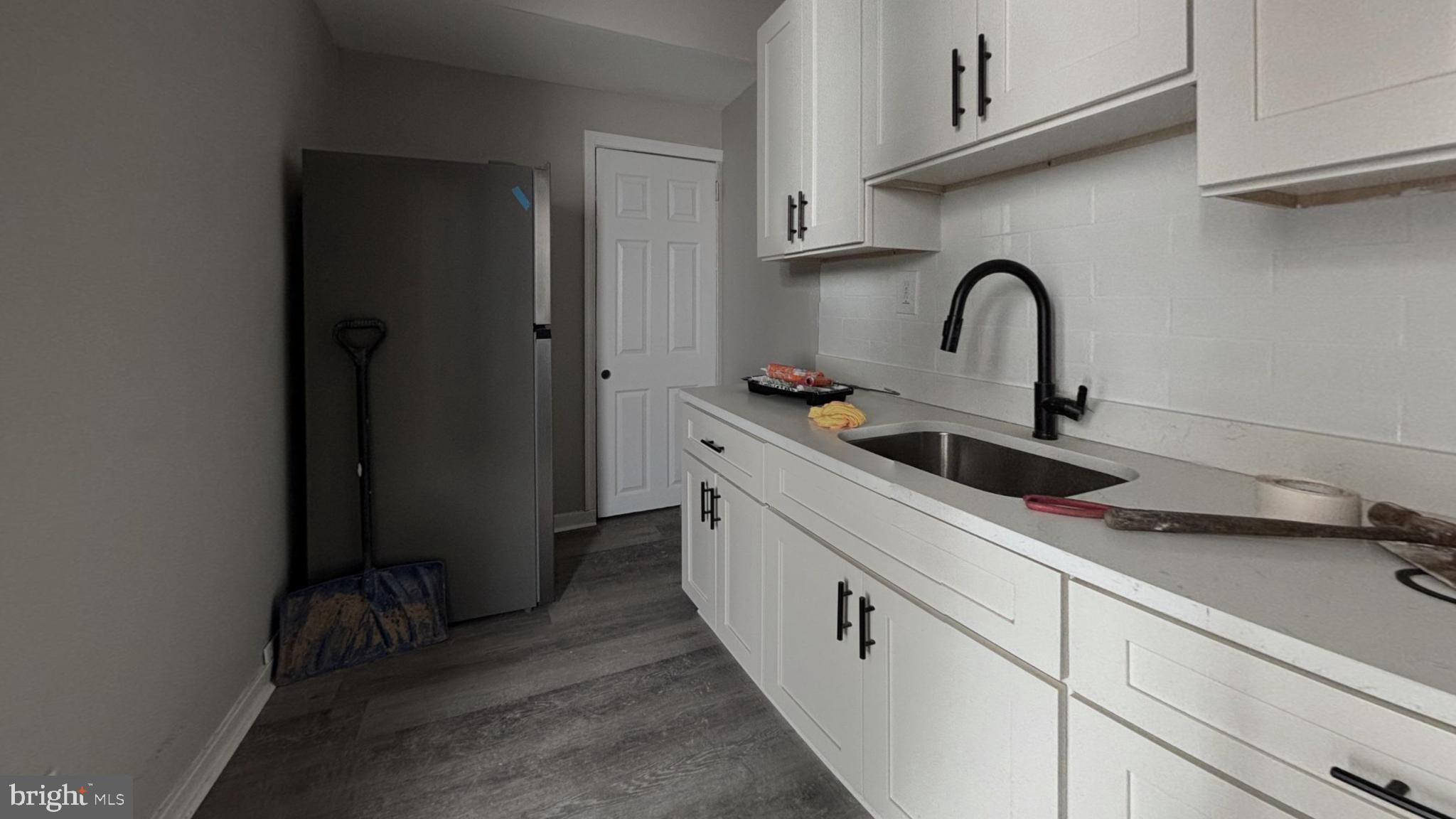 2644 South Felton Street Philadelphia, PA 19142 - Photo 3 of 9 a kitchen with a sink and cabinets