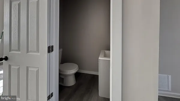 a white toilet sitting next to a shower