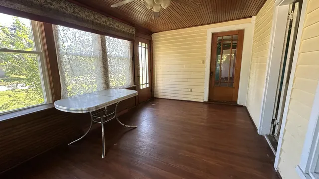 a view of a room with wooden floor and stairs
