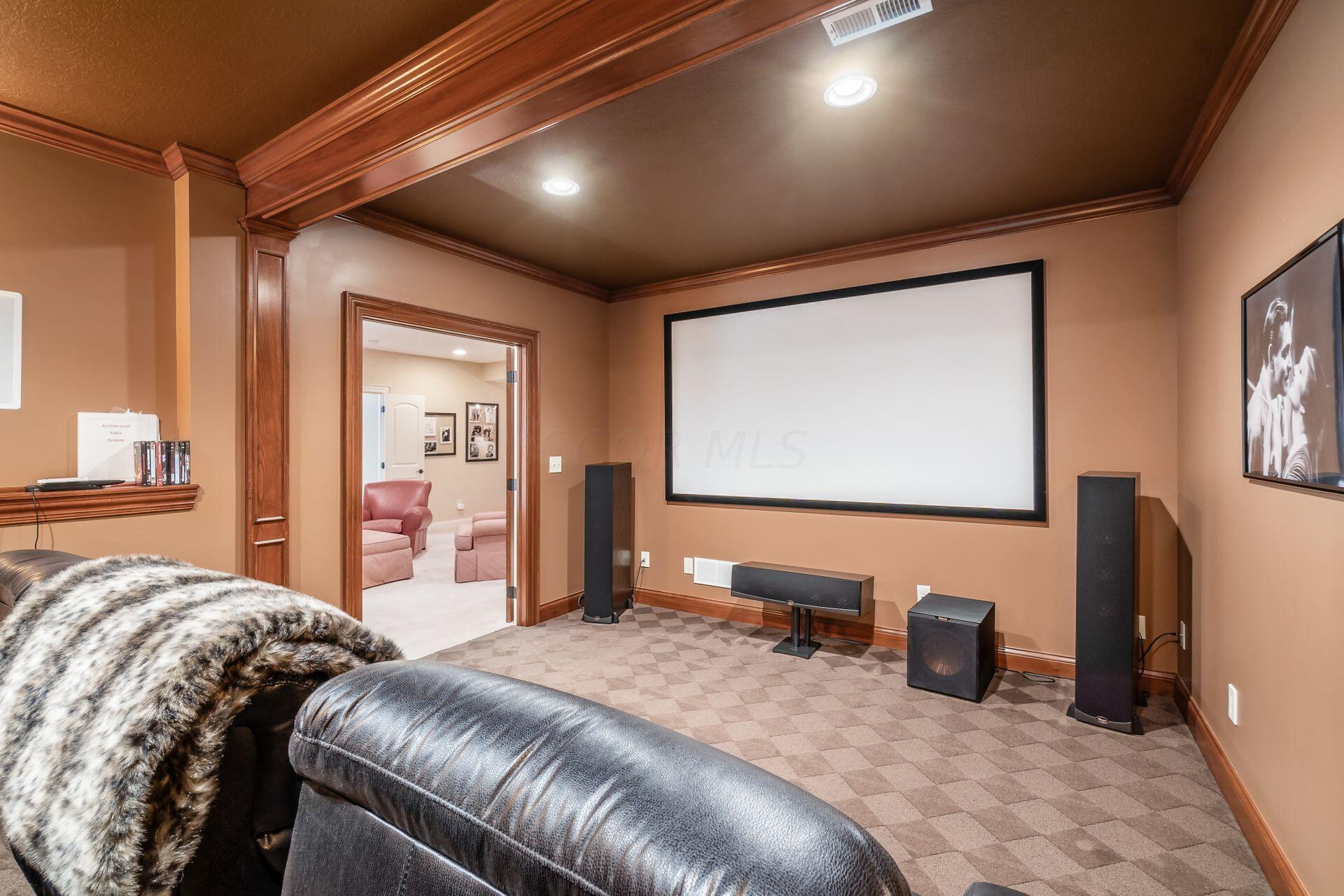 5475 Slater Ridge Westerville, OH 43082 - Photo 45 of 51 The lower level home theater room is designed for ultimate relaxation, featuring plush seating, a large screen, and advanced audio-visual equipment, creating a perfect setting for cinematic experiences.