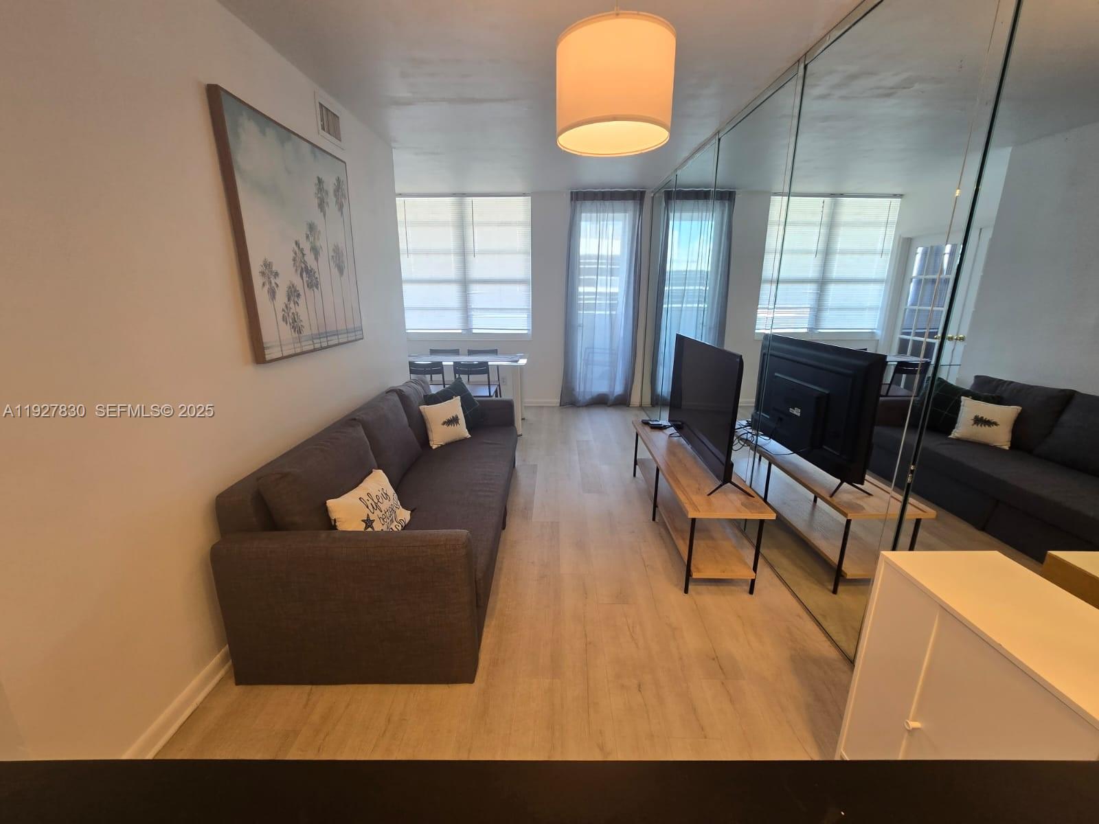 100 Lincoln Road, Unit 1227 Miami Beach, FL 33139 - Photo 5 of 11 a living room with furniture and a window