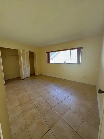 an empty room with a empty space and windows