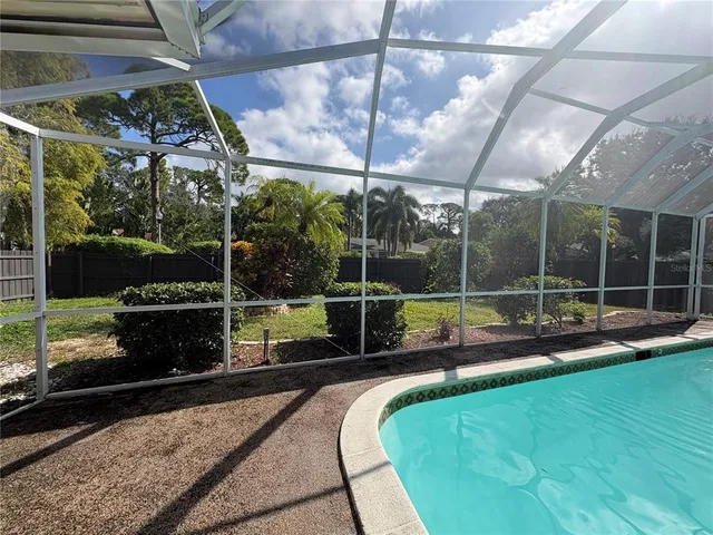 a view of a backyard with sitting area and tub