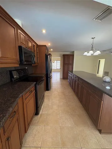 a kitchen with granite countertop a sink and cabinets