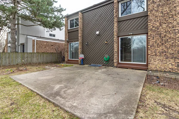 a backyard of a house with barbeque oven and outdoor seating