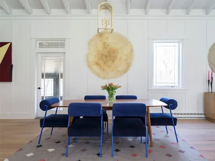 a dining room with furniture and wooden floor
