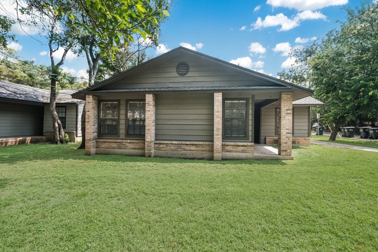 1102 Academy Street San Marcos, TX 78666 - Photo 2 of 17 a front view of a house with a yard