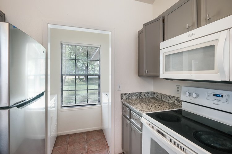 1102 Academy Street San Marcos, TX 78666 - Photo 9 of 17 a kitchen with a stove microwave and cabinets