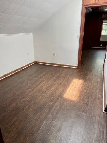 an empty room with wooden floor