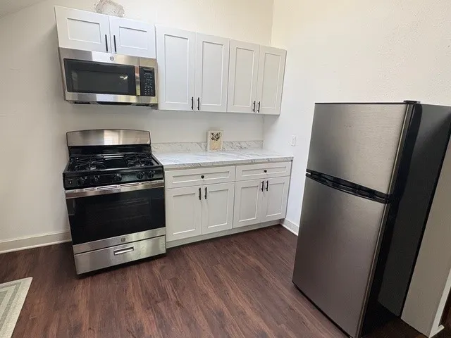 a kitchen with a refrigerator stove and microwave