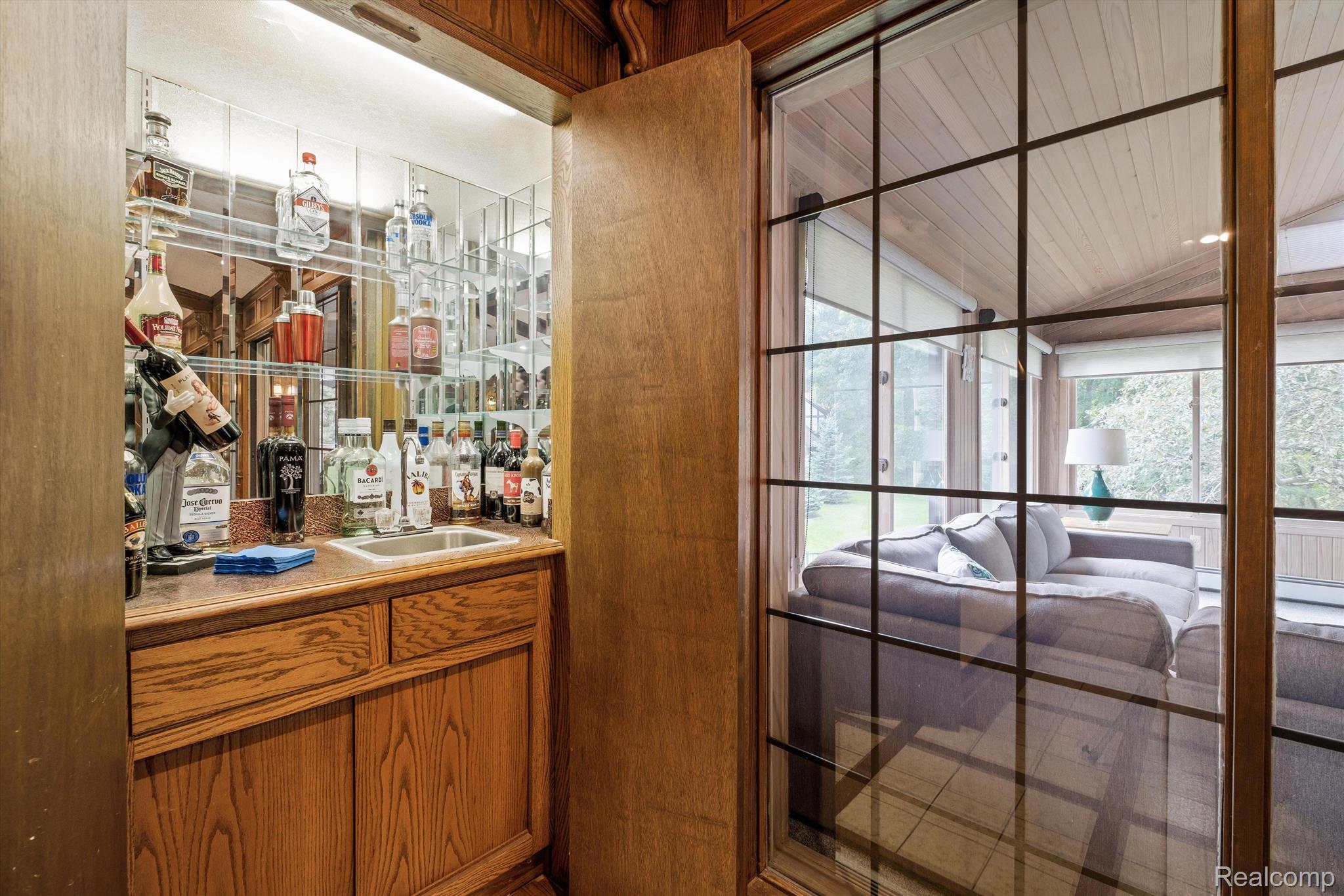 5262 North Livernois Road Rochester, MI 48306 - Photo 14 of 65 Hidden wet bar by 4 seasons room & fireplace