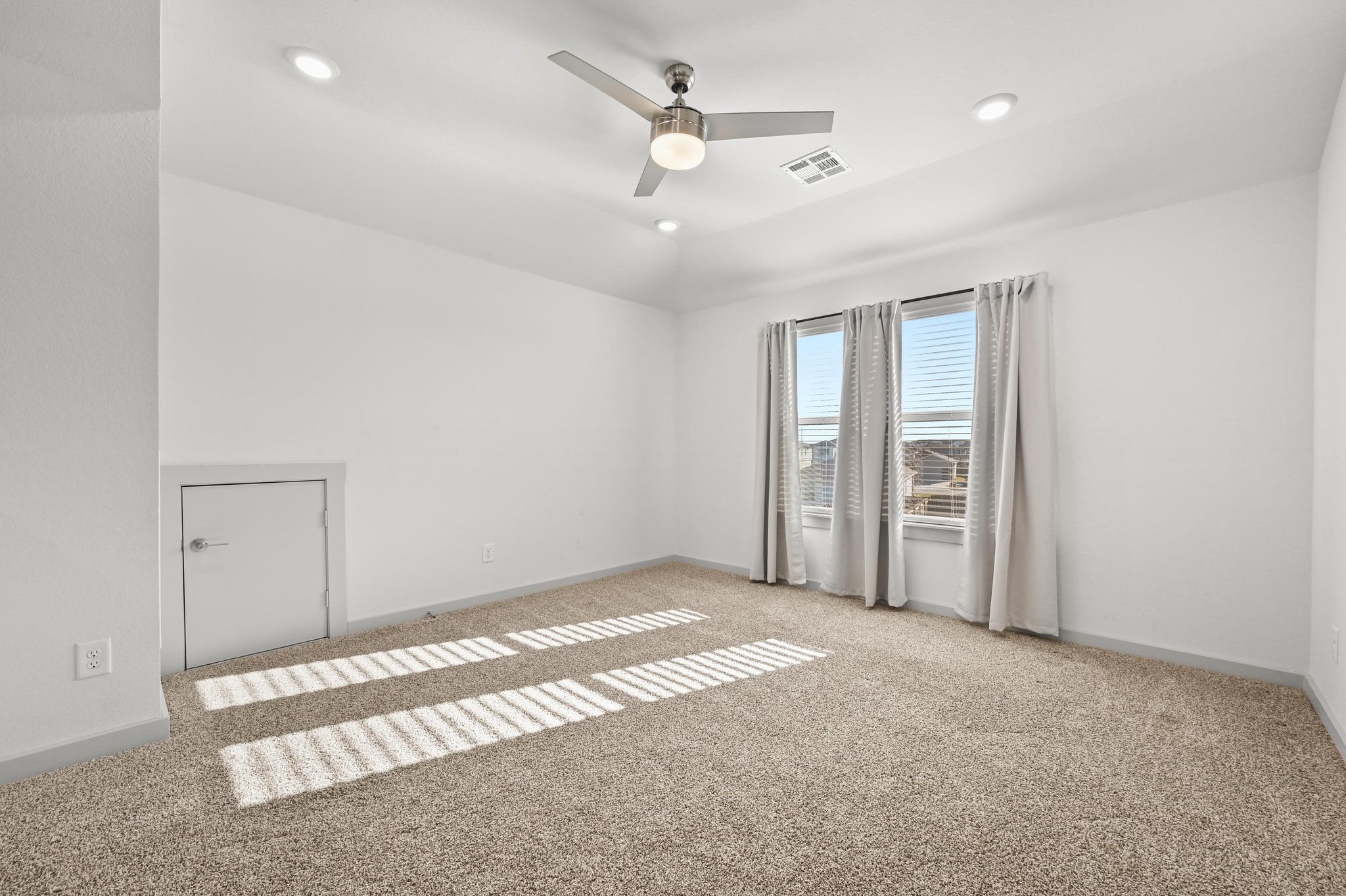 522 Wilshire Road San Marcos, TX 78666 - Photo 16 of 22 an empty room with chandelier fan and windows
