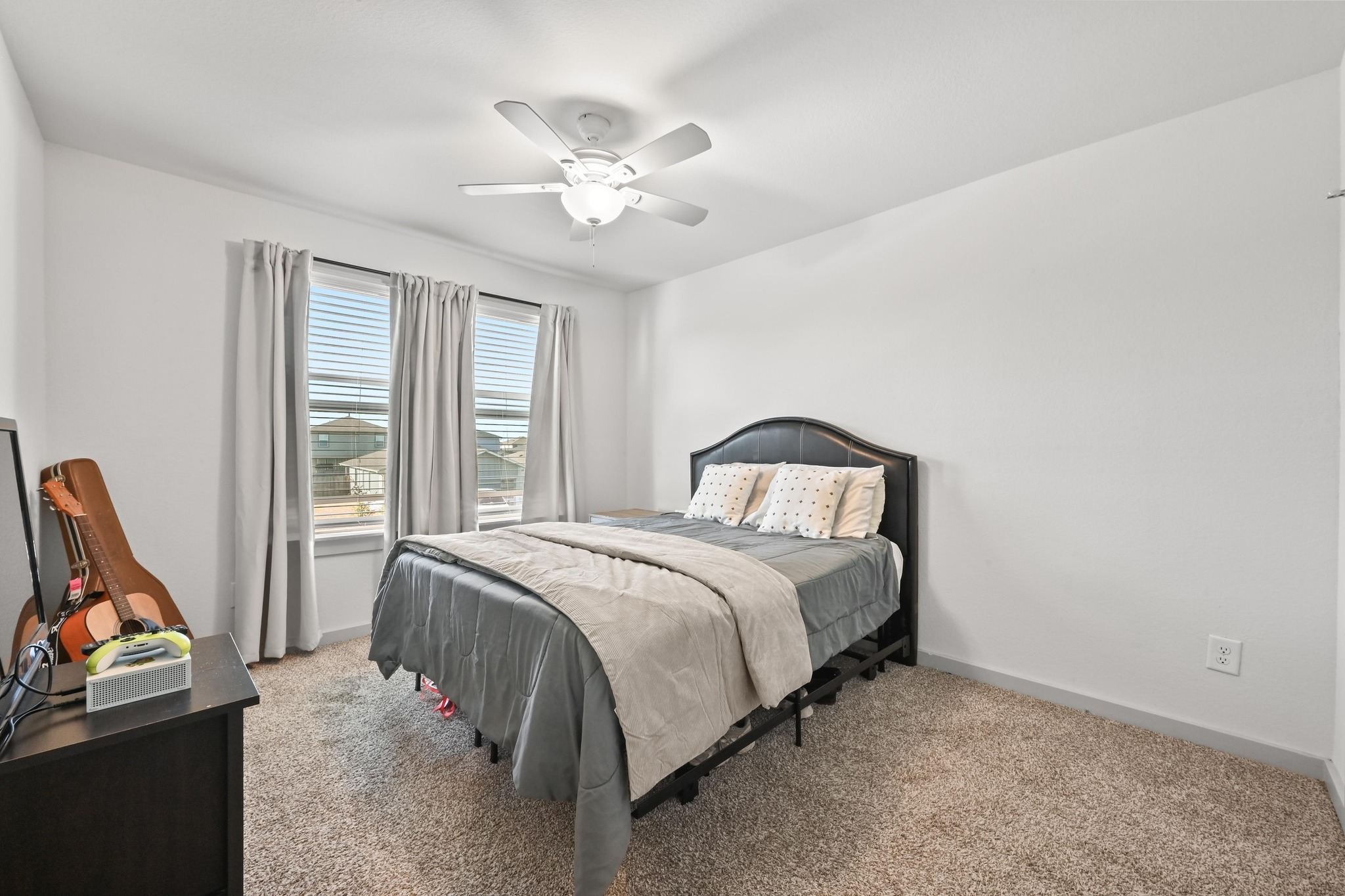 522 Wilshire Road San Marcos, TX 78666 - Photo 16 of 22 a bedroom with a bed and a chandelier