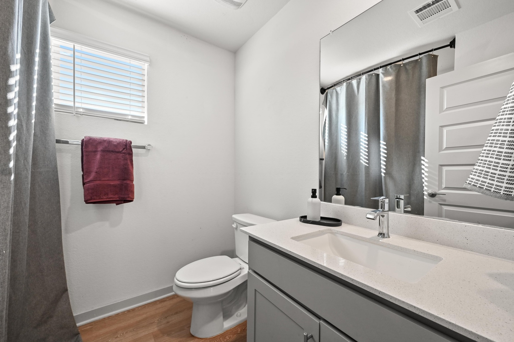 522 Wilshire Road San Marcos, TX 78666 - Photo 17 of 22 a bathroom with a granite countertop sink toilet and mirror