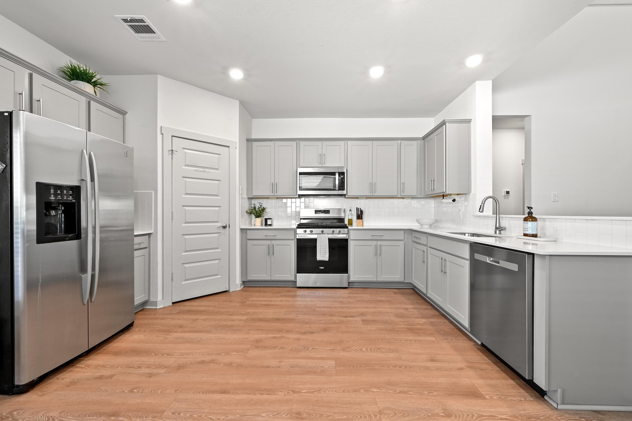 522 Wilshire Road San Marcos, TX 78666 - Photo 6 of 22 a kitchen with a refrigerator sink and cabinets