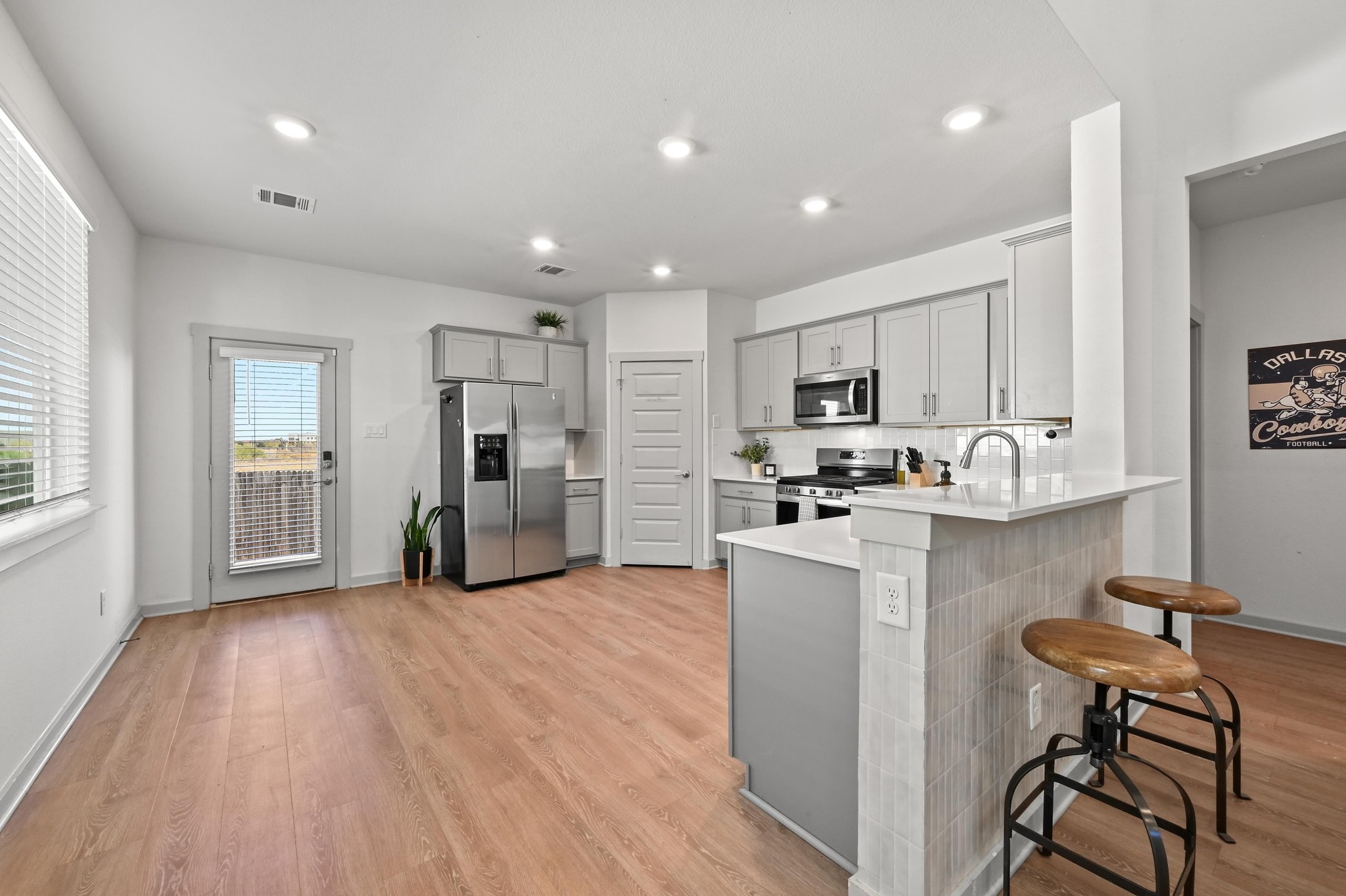 522 Wilshire Road San Marcos, TX 78666 - Photo 6 of 22 a kitchen with a refrigerator and a stove top oven