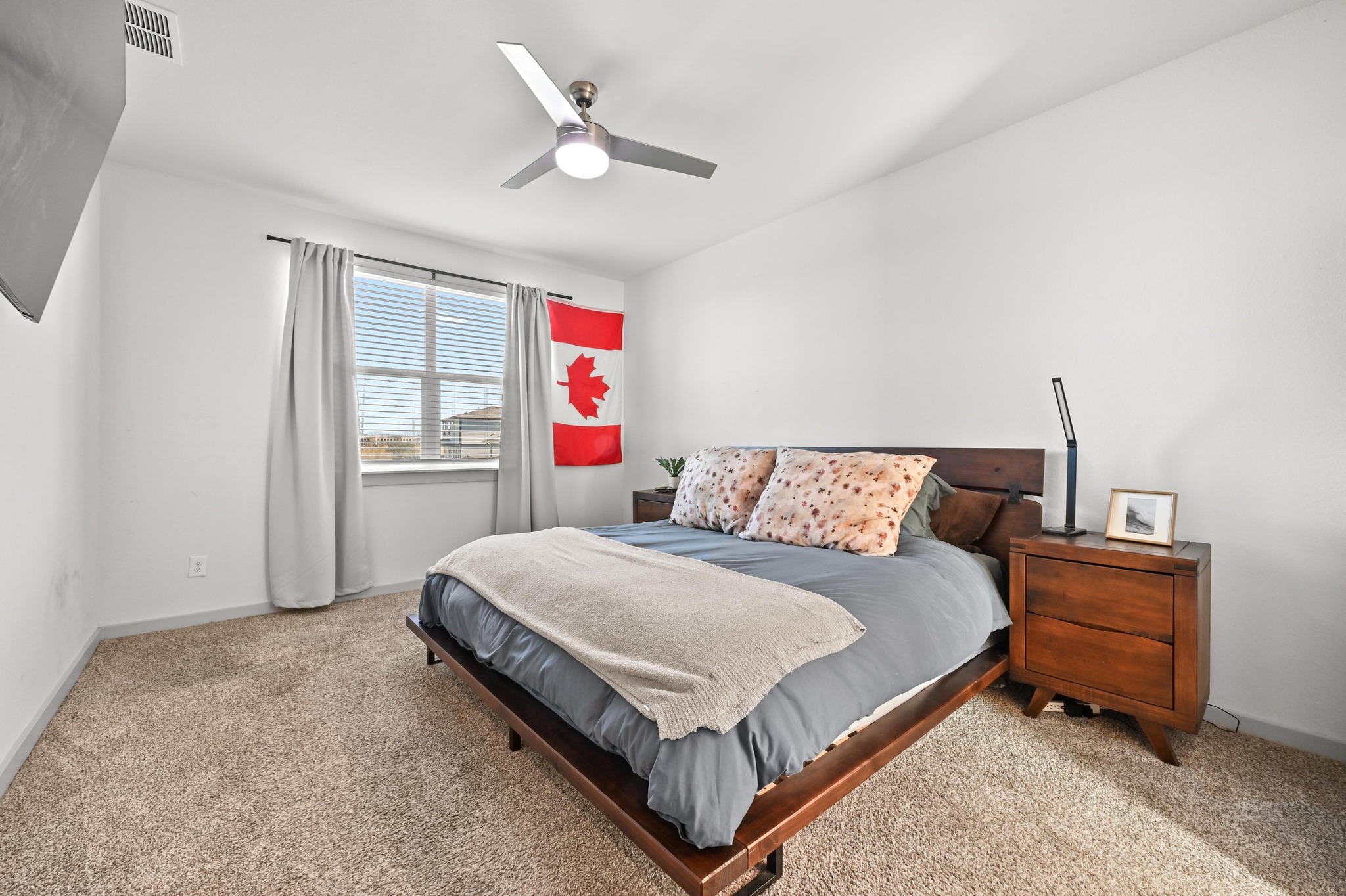 522 Wilshire Road San Marcos, TX 78666 - Photo 10 of 22 a bedroom with a bed chandelier and a window
