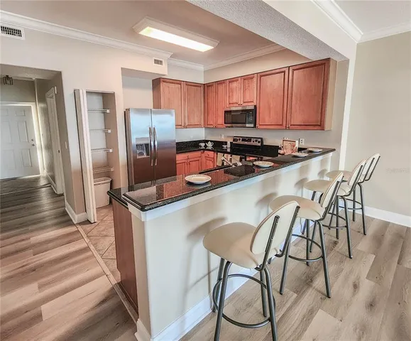 a kitchen with stainless steel appliances a stove a refrigerator and a refrigerator