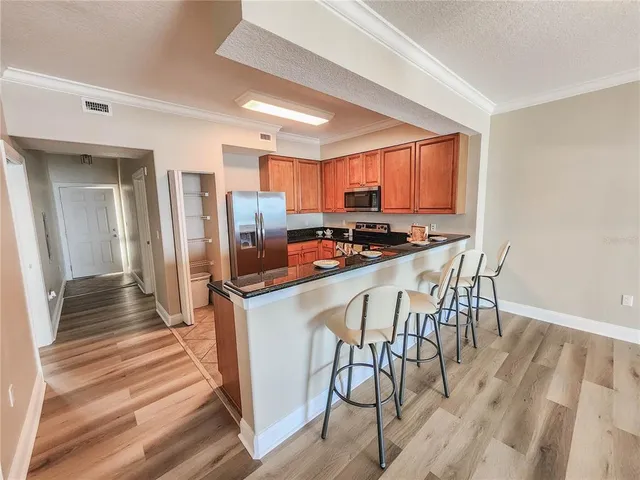 a kitchen with stainless steel appliances a stove a sink refrigerator and a microwave