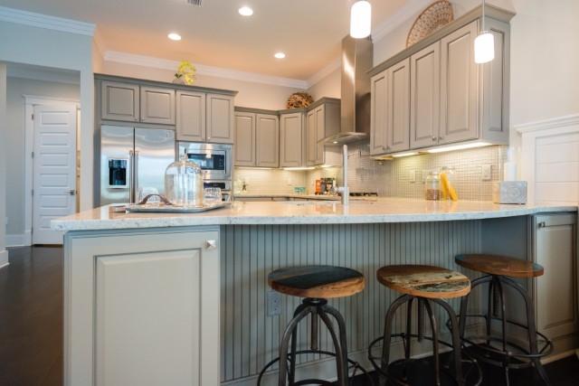 52 Clipper Street Inlet Beach, FL 32461 - Photo 22 of 34 a kitchen with stainless steel appliances granite countertop a table chairs sink refrigerator and cabinets