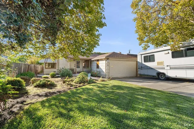 a backyard of a house with table and chairs
