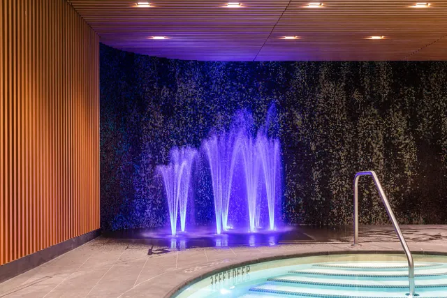 a view of a hall with wooden floor and a staircase