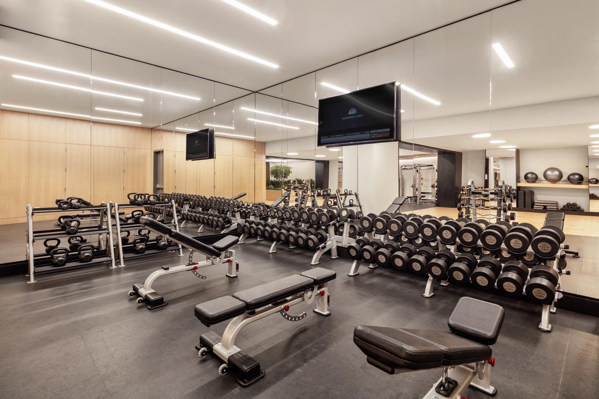 111 Murray Street, Unit 11B Manhattan, NY 10007 - Photo 21 of 25 a room with gym equipment and a large window