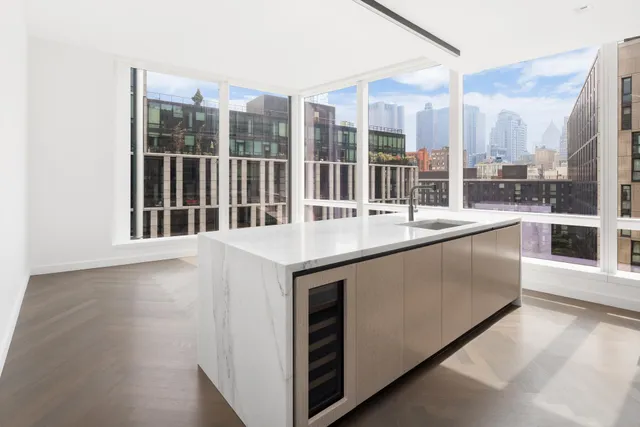 a large white kitchen with a large window