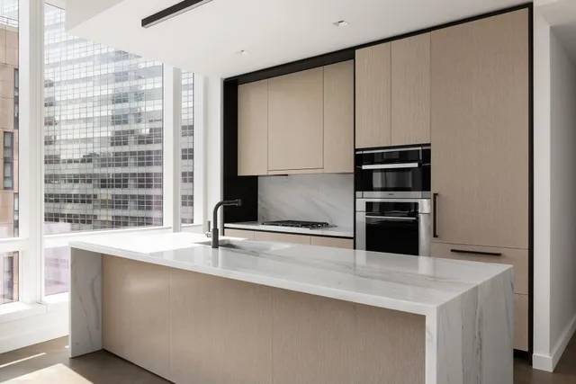 a kitchen with stainless steel appliances a sink and a refrigerator