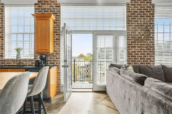 a living room with furniture and a floor to ceiling window