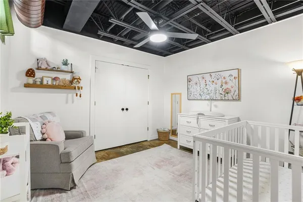 a spacious bedroom with a bed and a chandelier