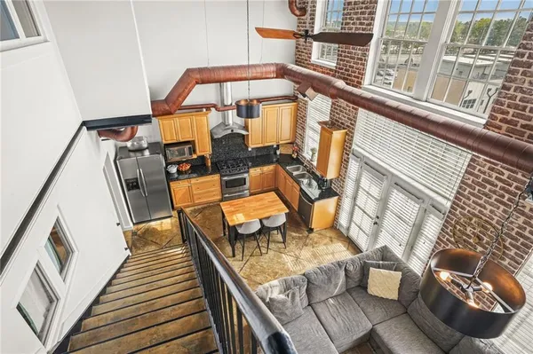 a view of a balcony with chairs and wooden floor