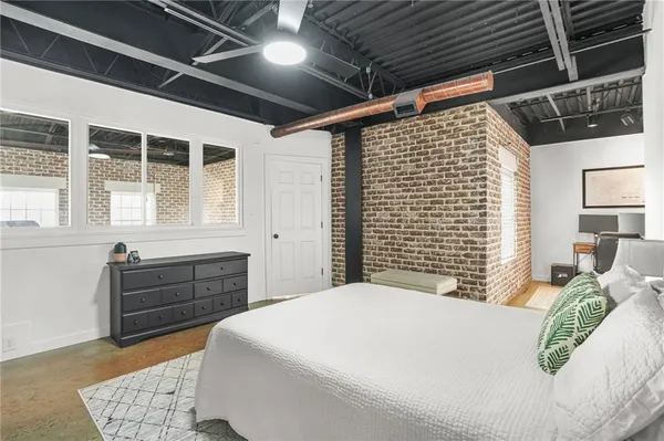 a bedroom with a large bed and a window