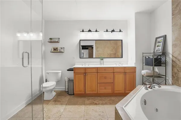 a bathroom with a sink a toilet and mirror