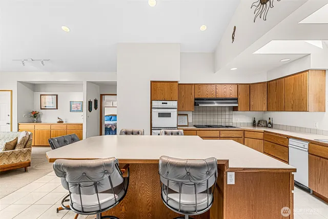 a large kitchen with a table and chairs in it
