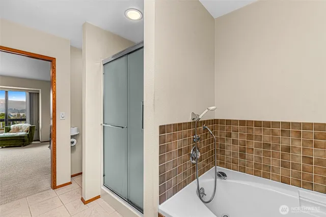 a bathroom with a bathtub and a shower