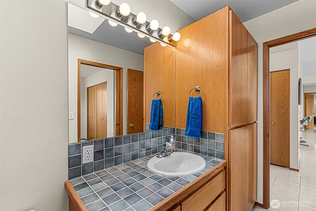 a bathroom with a double vanity sink and a mirror