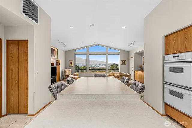 a large white kitchen with a large window
