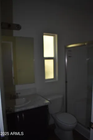 a bathroom with a toilet a sink and a window